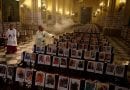 Powerful image of Archbishop  in cathedral surrounded by pictures of Coronavirus victims